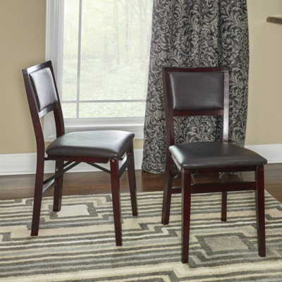 Two chairs in a room with a rug