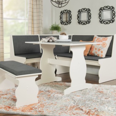 A white dining table with two benches, creating a simple and elegant seating arrangement