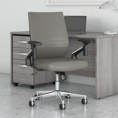 A gray office chair with a desk and a laptop, creating a productive workspace