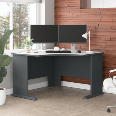 A computer desk with two monitors and a chair