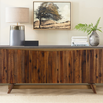 a wooden cabinet with a lamp and a plant on top