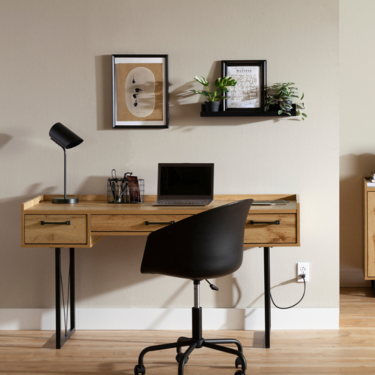 a desk with a chair and a laptop