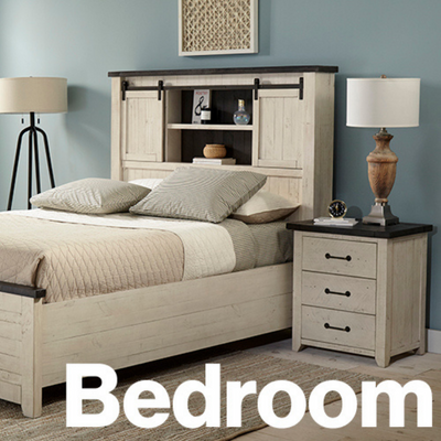 a bed with a bookcase and lamp