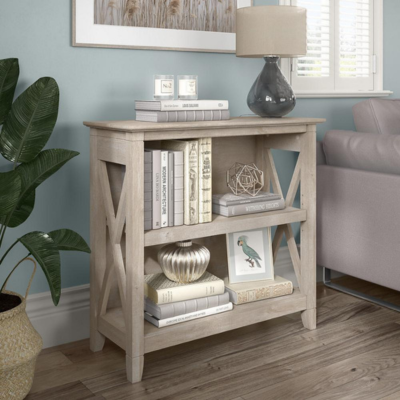 a book shelf with books and a lamp